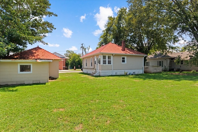 back of property featuring a lawn