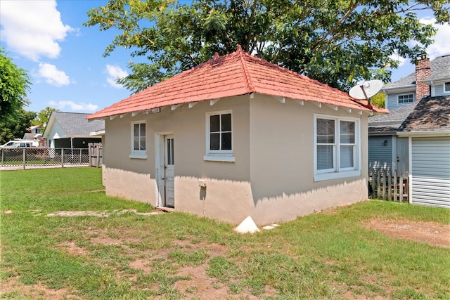 view of home's exterior with a lawn