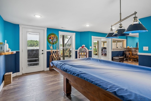 recreation room featuring pool table, hardwood / wood-style flooring, and bar