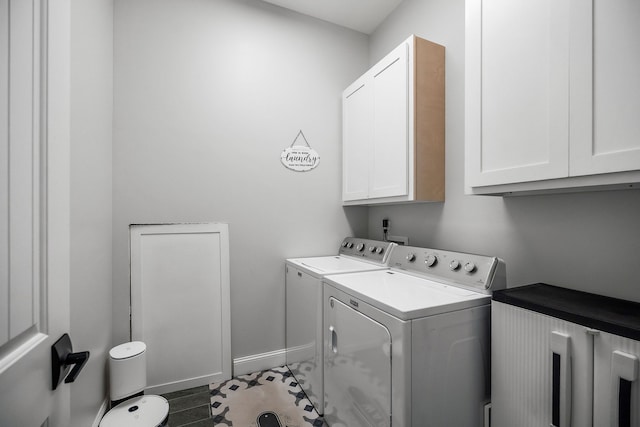 washroom featuring cabinets, dark hardwood / wood-style flooring, and washer and dryer