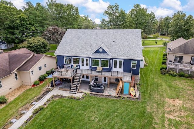 back of property with a deck and a lawn