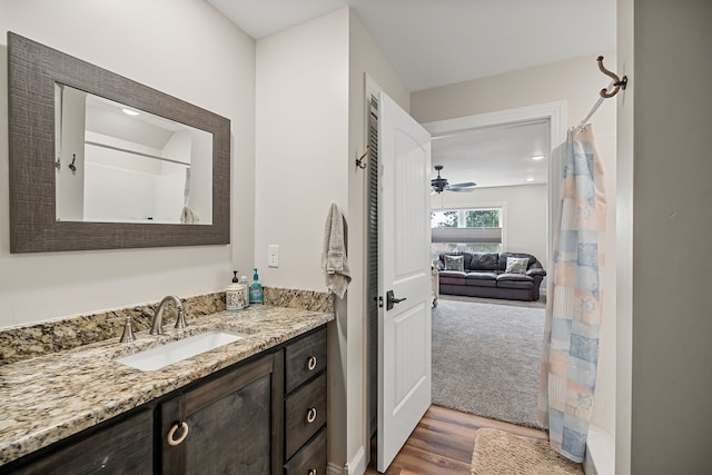 bathroom with vanity, ceiling fan, and hardwood / wood-style floors