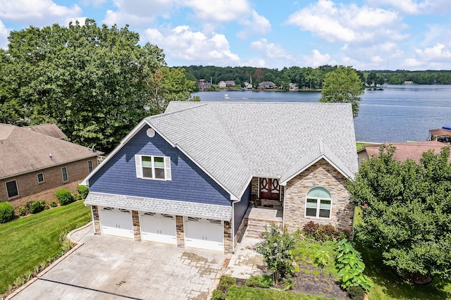 view of front of house with a water view and a garage