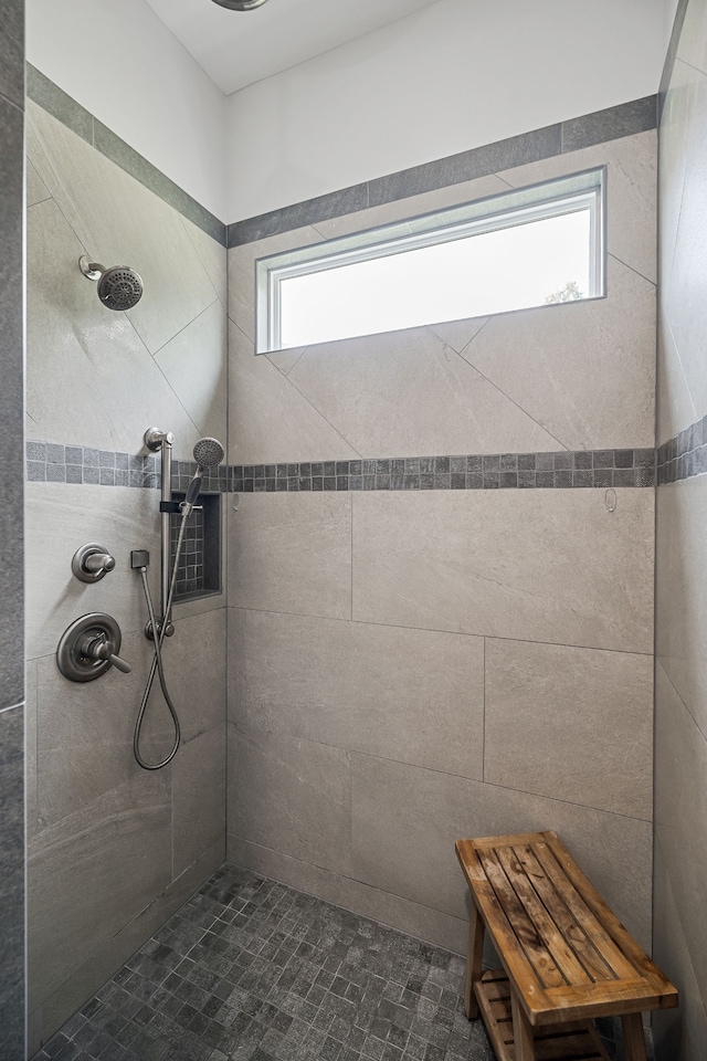 bathroom with a tile shower