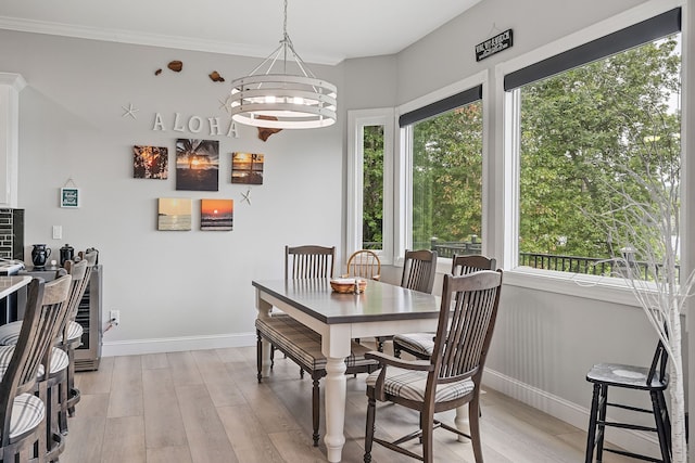 dining area featuring a healthy amount of sunlight, a chandelier, and light hardwood / wood-style floors