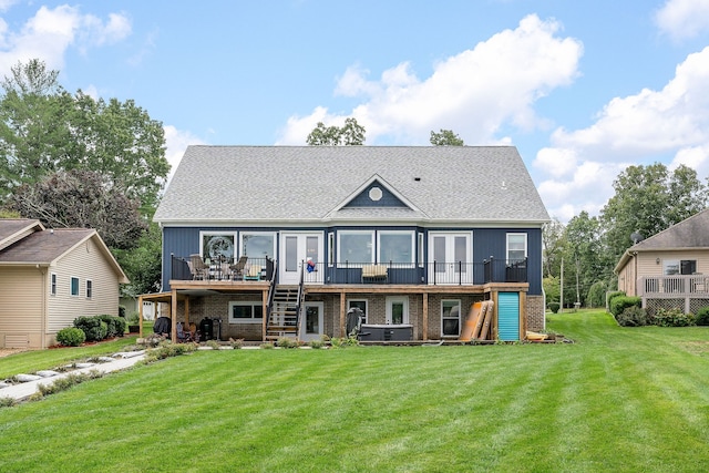 rear view of property with a deck and a lawn