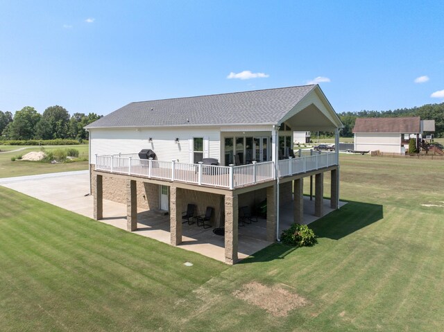 back of property featuring a patio, a wooden deck, and a yard