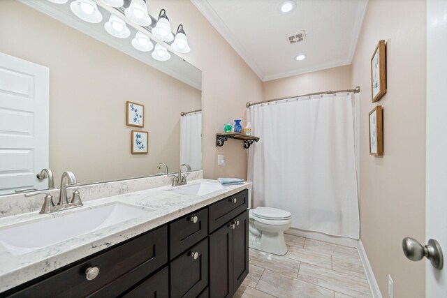 bathroom featuring ornamental molding, toilet, tile patterned floors, and dual bowl vanity