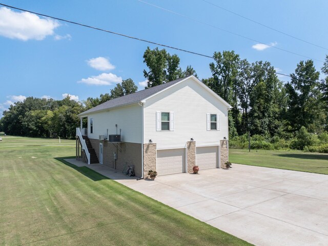 view of home's exterior featuring a garage and a lawn