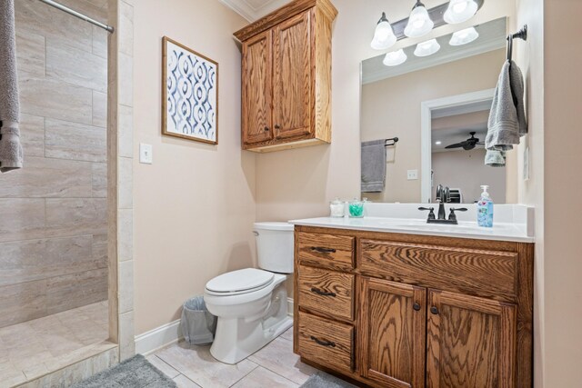 bathroom featuring toilet, vanity, ceiling fan, tile patterned floors, and ornamental molding