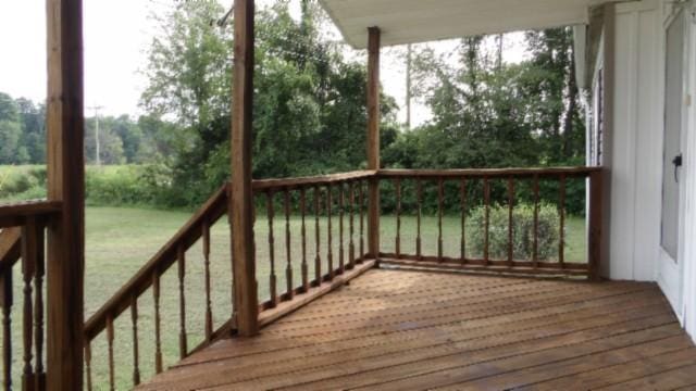 wooden terrace with a lawn