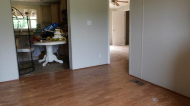 interior space with ceiling fan and dark hardwood / wood-style floors