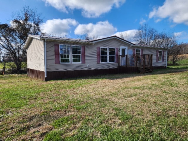 view of front facade featuring a front lawn and a deck