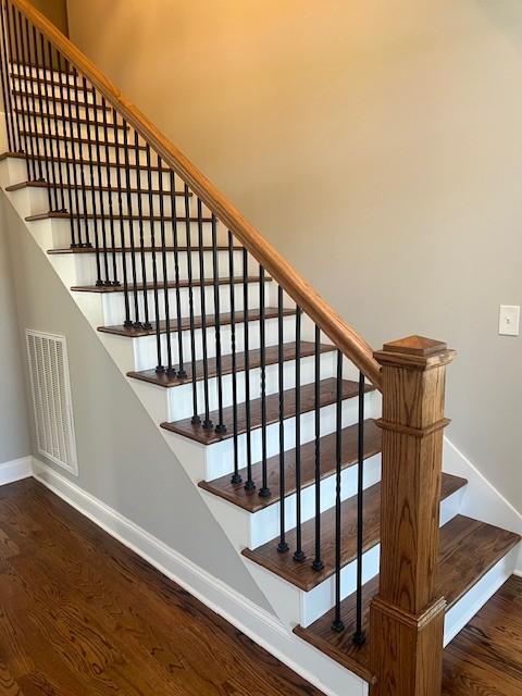 staircase with wood-type flooring