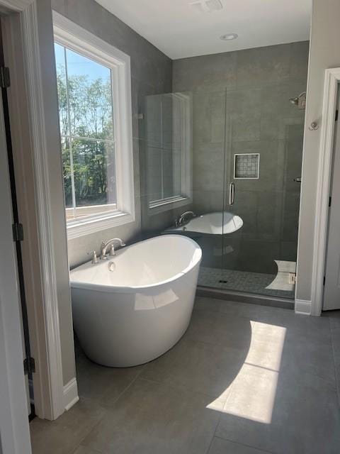 bathroom featuring plus walk in shower and tile patterned flooring