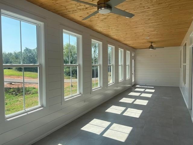 unfurnished sunroom with wood ceiling and ceiling fan