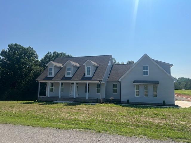 cape cod-style house featuring a front yard and a porch