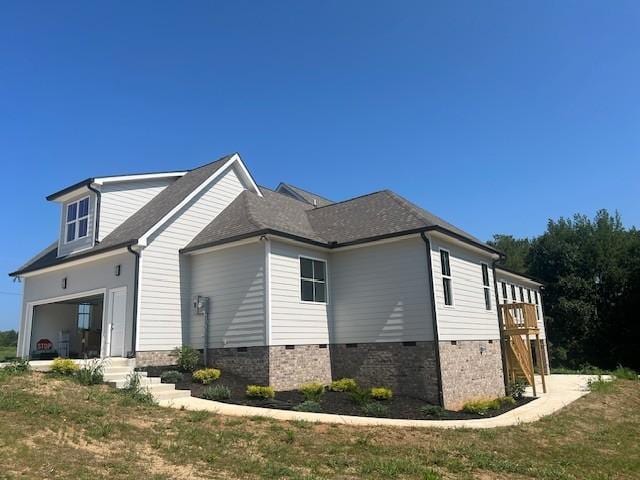 view of property exterior with a garage and a yard