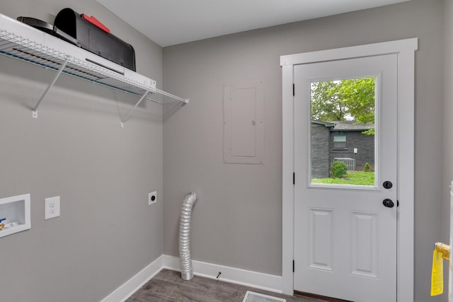 laundry room featuring a wealth of natural light, electric panel, baseboards, and hookup for an electric dryer