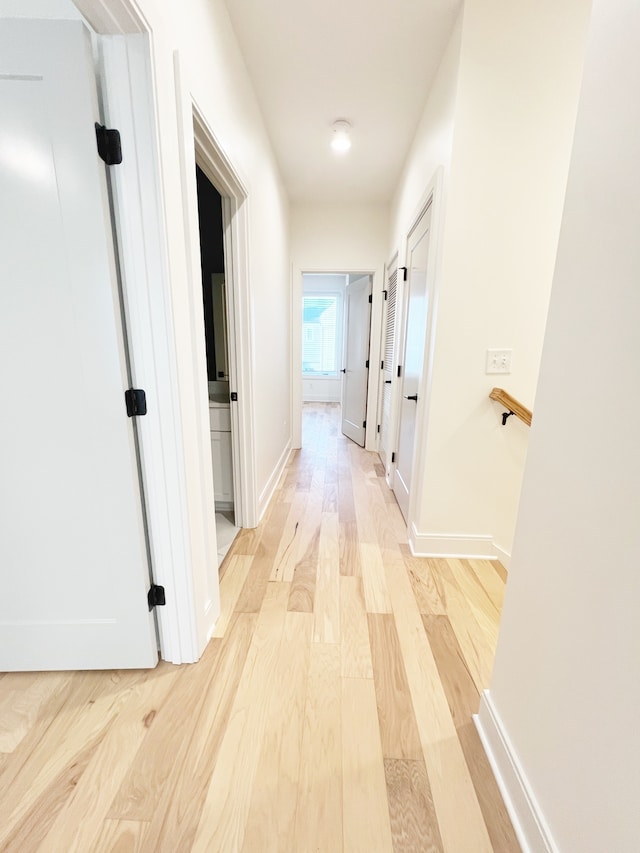 corridor with light hardwood / wood-style floors