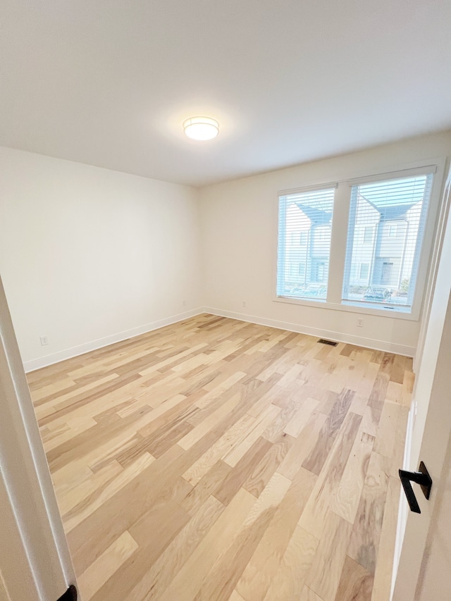 spare room featuring light hardwood / wood-style flooring