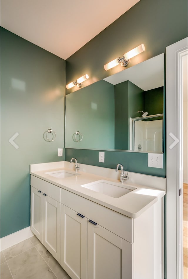 bathroom with double vanity and tile patterned flooring