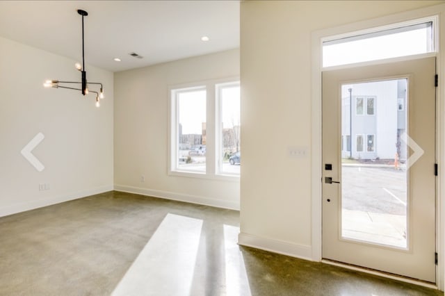 doorway to outside with carpet flooring and a chandelier