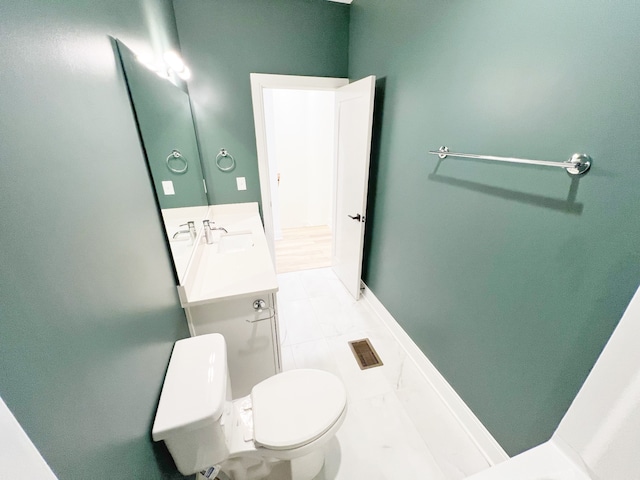 bathroom with vanity, toilet, and tile patterned flooring