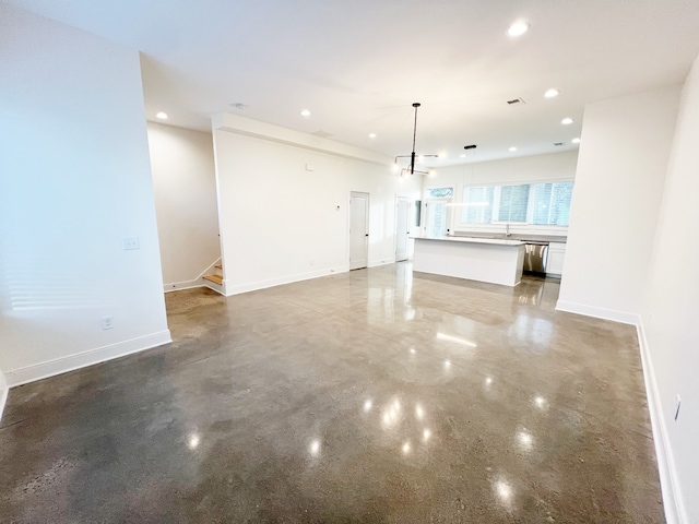 unfurnished living room with concrete flooring