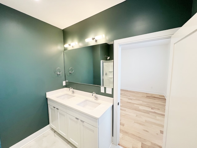 bathroom featuring double vanity and hardwood / wood-style flooring