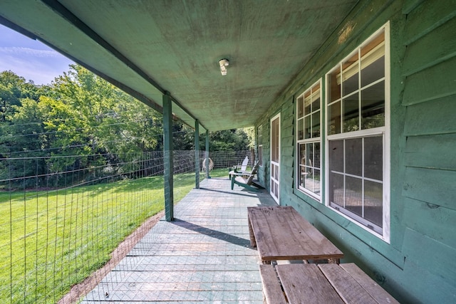 wooden deck featuring a lawn and fence