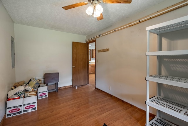 interior space with ceiling fan and electric panel