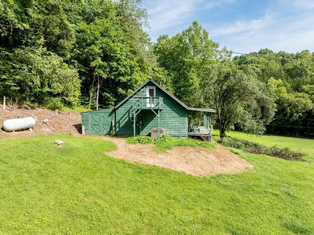 rear view of property featuring a yard