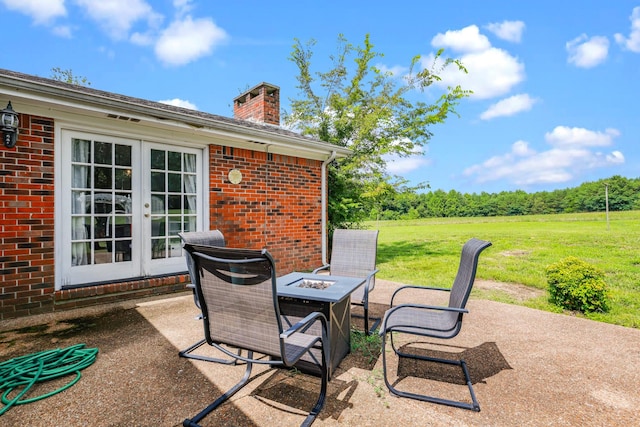 view of patio with french doors and a fire pit