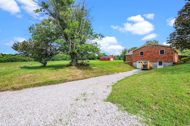 view of yard with a garage and gravel driveway