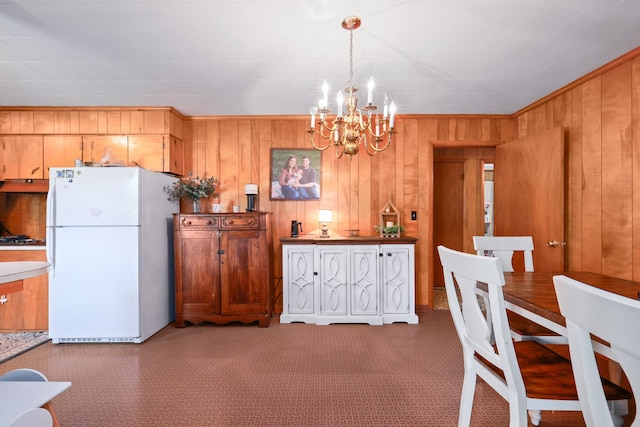 interior space with an inviting chandelier and wooden walls