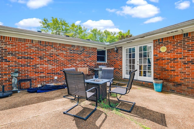 view of patio with french doors and an outdoor fire pit