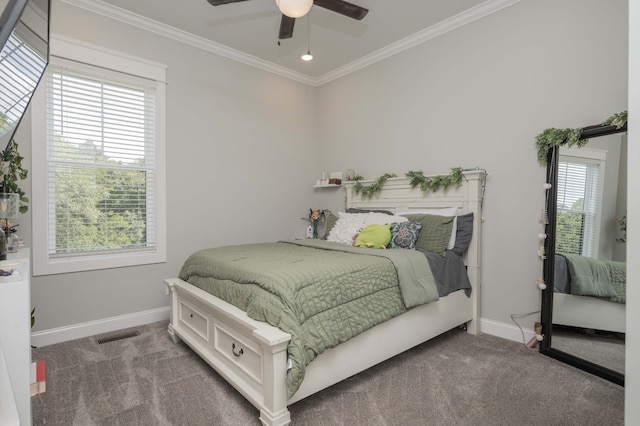 carpeted bedroom featuring ceiling fan, ornamental molding, and multiple windows