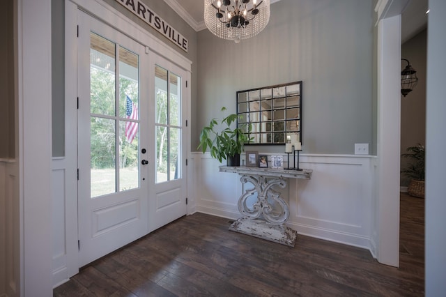 doorway featuring french doors, an inviting chandelier, crown molding, and dark wood-type flooring