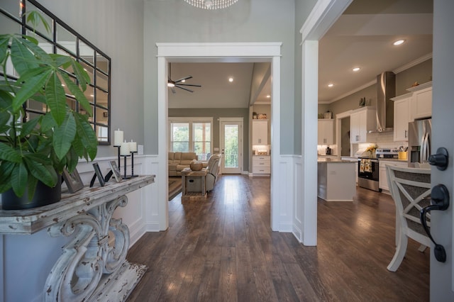 entrance foyer with ceiling fan, dark hardwood / wood-style flooring, and crown molding