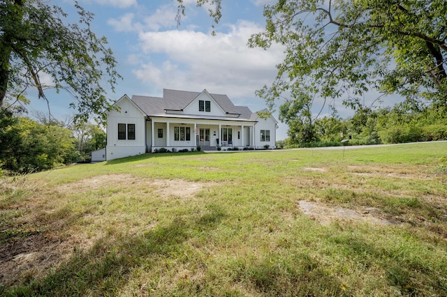 cape cod-style house featuring a porch and a front lawn