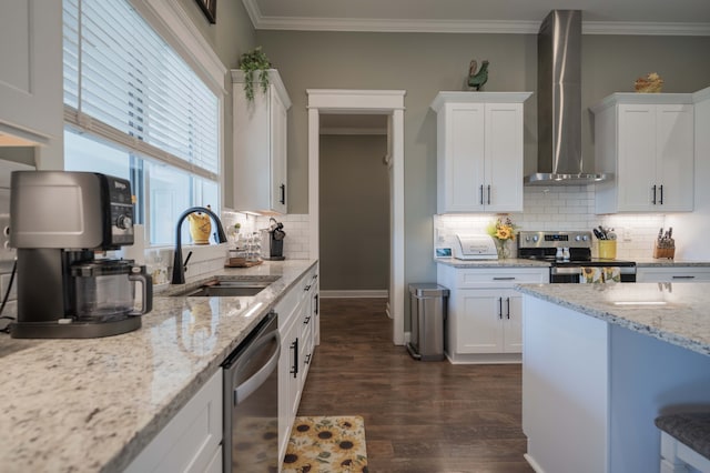 kitchen featuring sink, wall chimney exhaust hood, dark hardwood / wood-style floors, appliances with stainless steel finishes, and white cabinetry