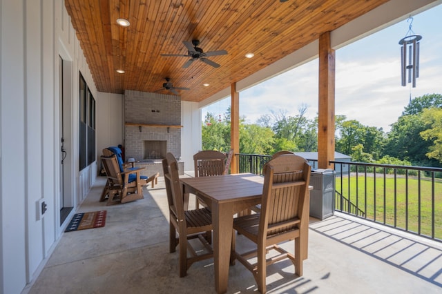 view of patio with an outdoor brick fireplace and ceiling fan