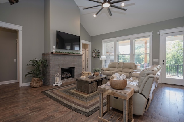 living room with a fireplace, dark wood-type flooring, high vaulted ceiling, and a healthy amount of sunlight