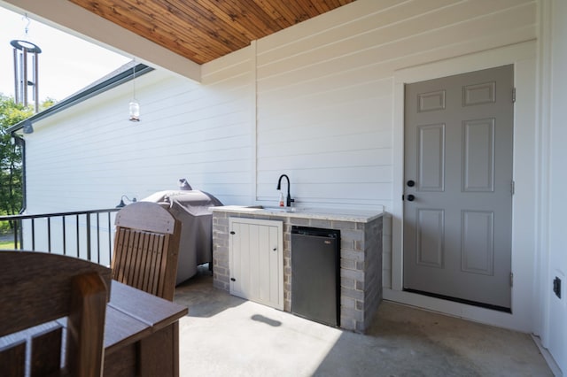 view of patio / terrace featuring sink, exterior kitchen, and a grill