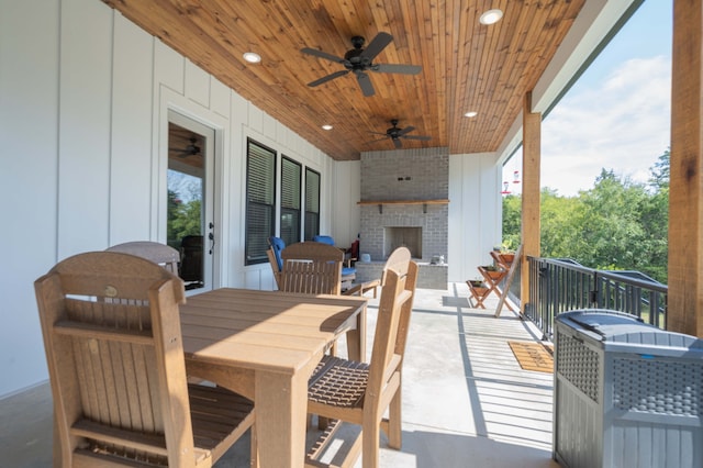 view of patio / terrace featuring ceiling fan and an outdoor brick fireplace