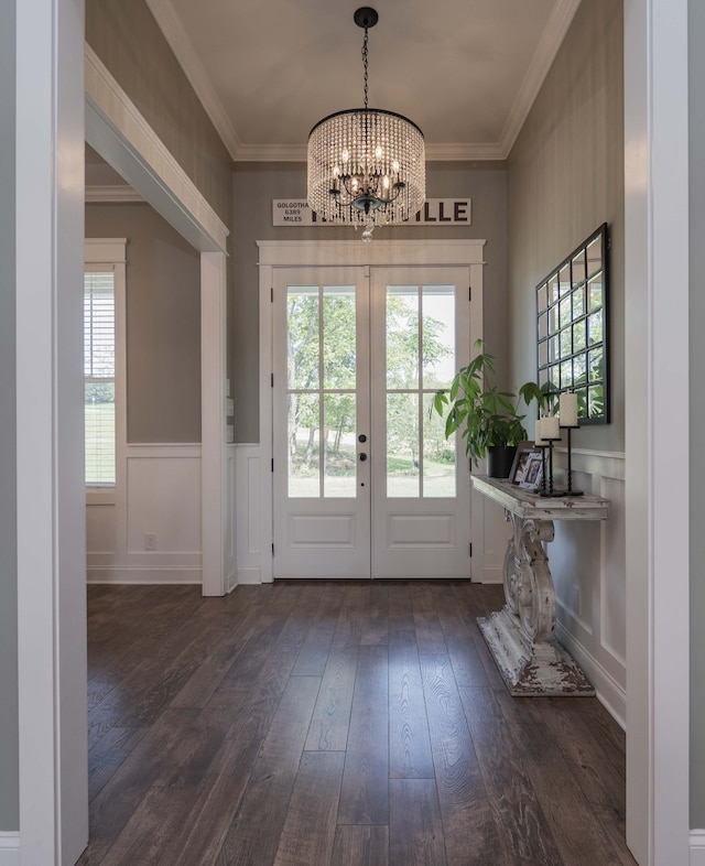 entryway with crown molding, french doors, a chandelier, and dark hardwood / wood-style floors