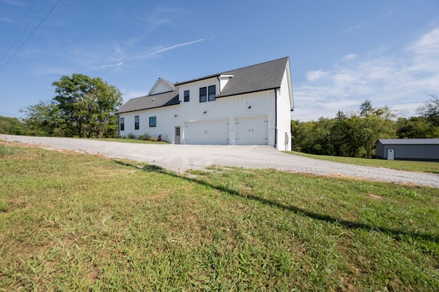 view of front of home with a front yard and a garage