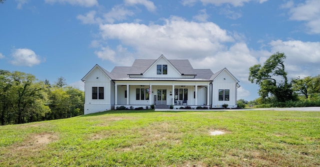 modern farmhouse style home featuring covered porch and a front lawn