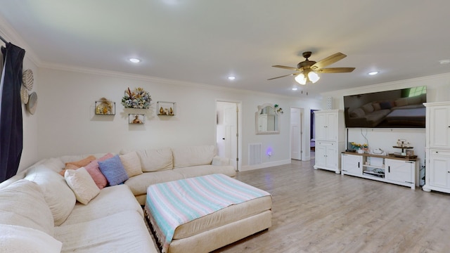 living room featuring ceiling fan, light wood-type flooring, and crown molding